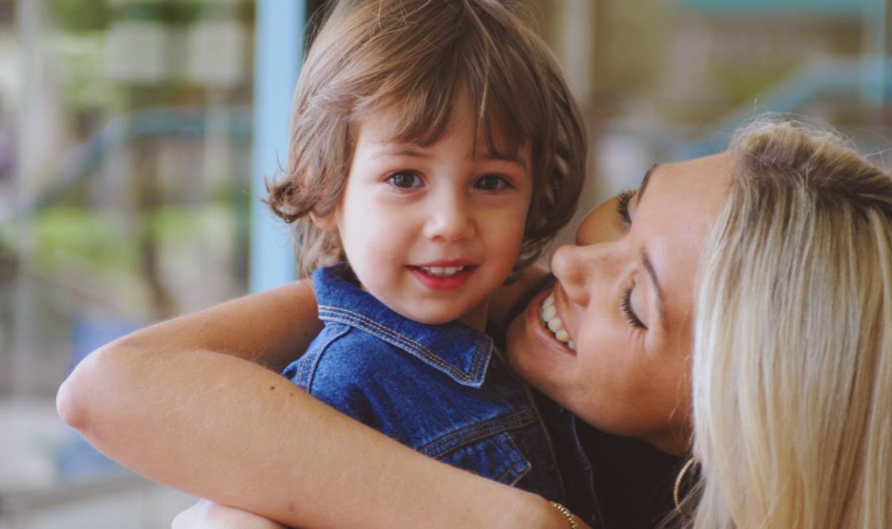 Happy Mother and Child Embracing Indoors