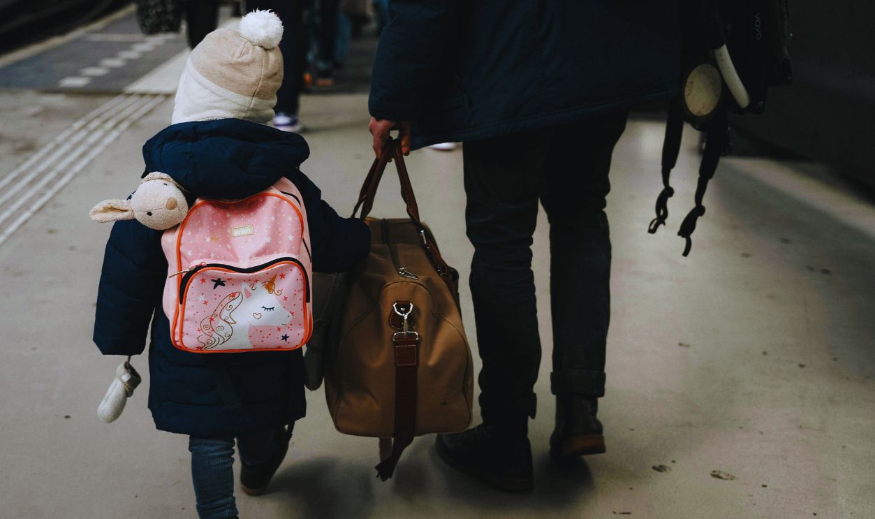 Child and Adult Traveling on Amsterdam Train Platform