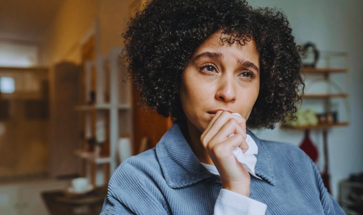 Crying upset black female with tissue