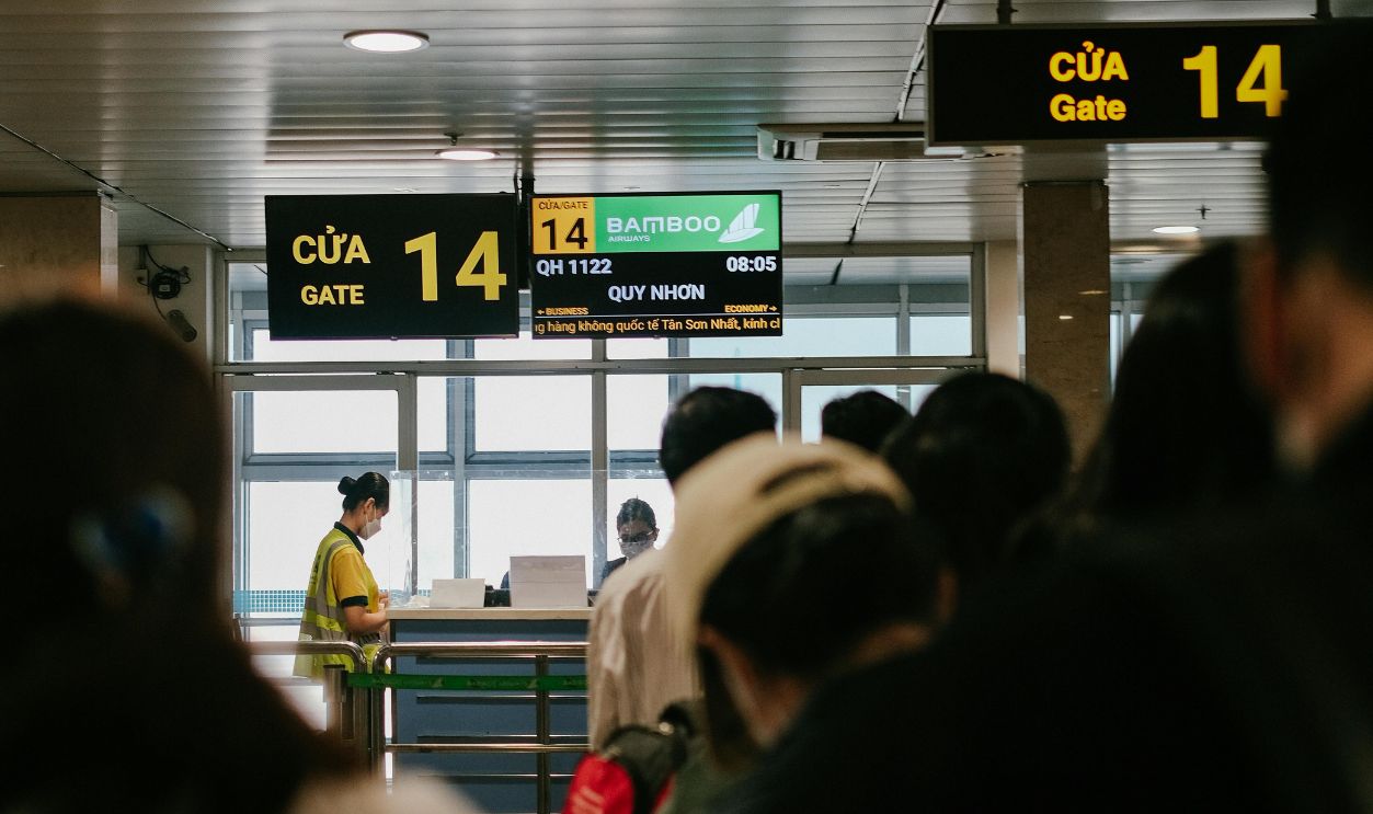 Back View of People Queuing at an Airport Gate