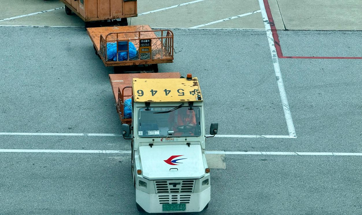 Airport Tow Tractor Pulling Cargo Containers