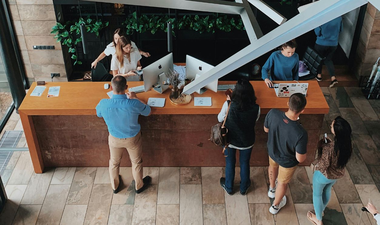 High Angle View on People at the Reception Desk in a Hotel