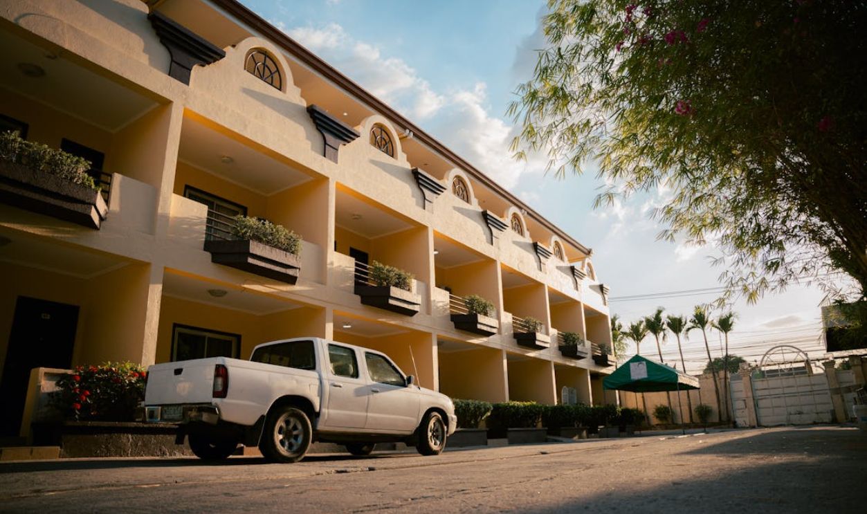 White Pickup Truck on Parking Lot of Hotel