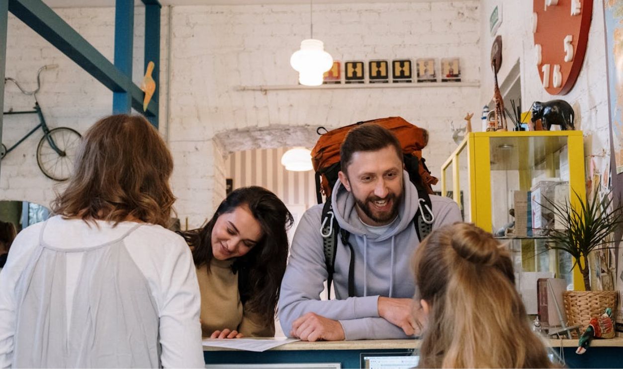 Tourist Standing in front of Reception Desk