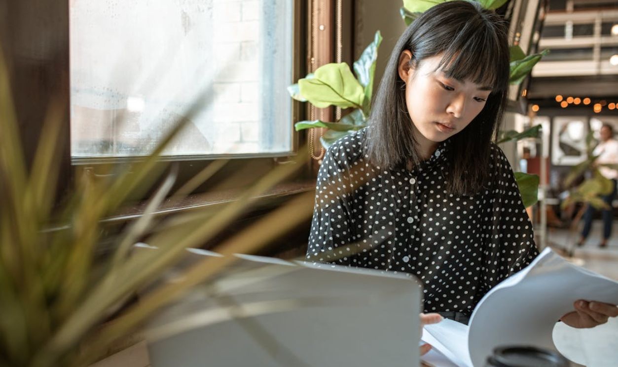 A Woman Reading Documents