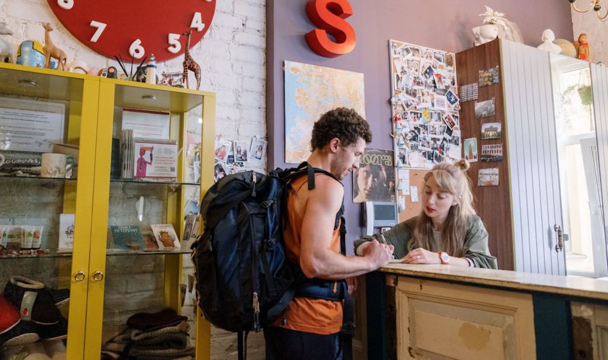 Tourist Standing in front of Reception Desk