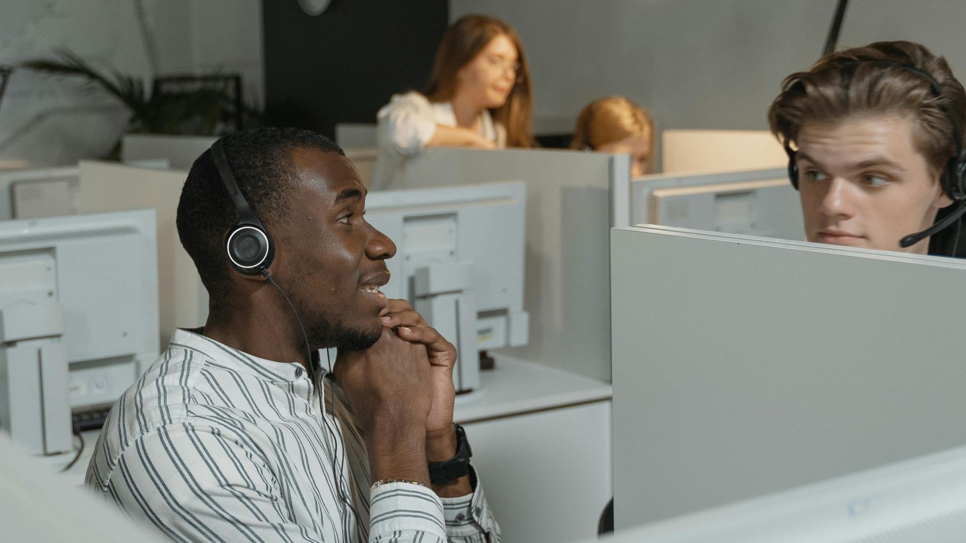 Call center team collaborating with headsets, providing efficient customer support.