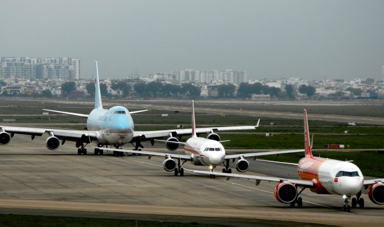 Airplanes Taxi on Runway at Bustling Airport