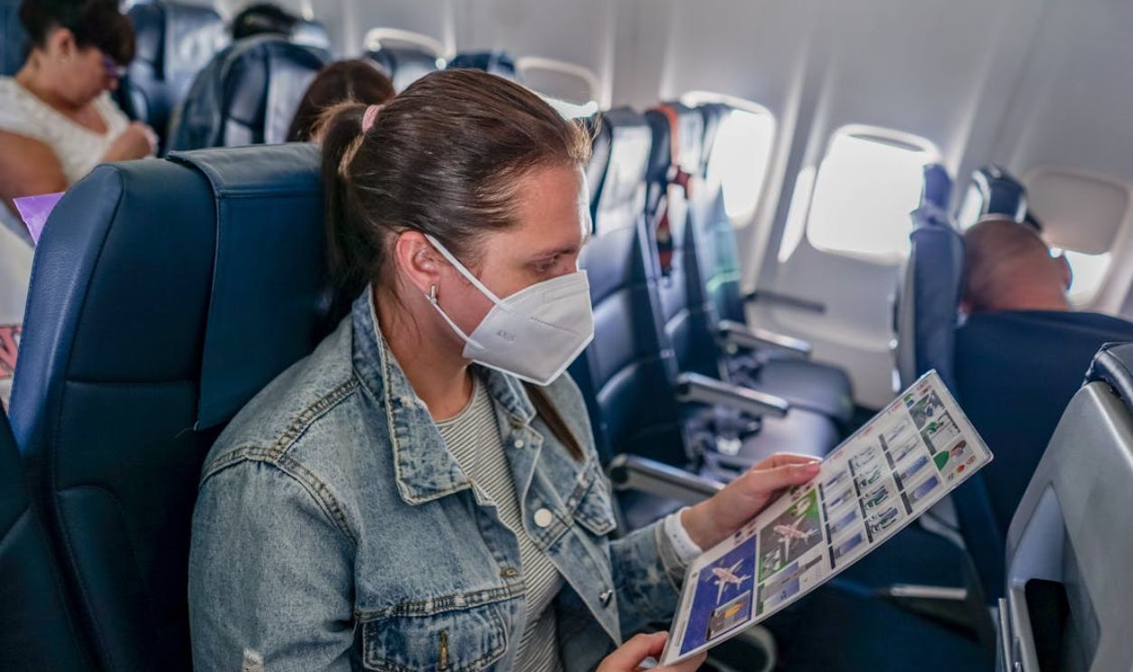 Woman in Denim Jacket Sitting inside the Plane