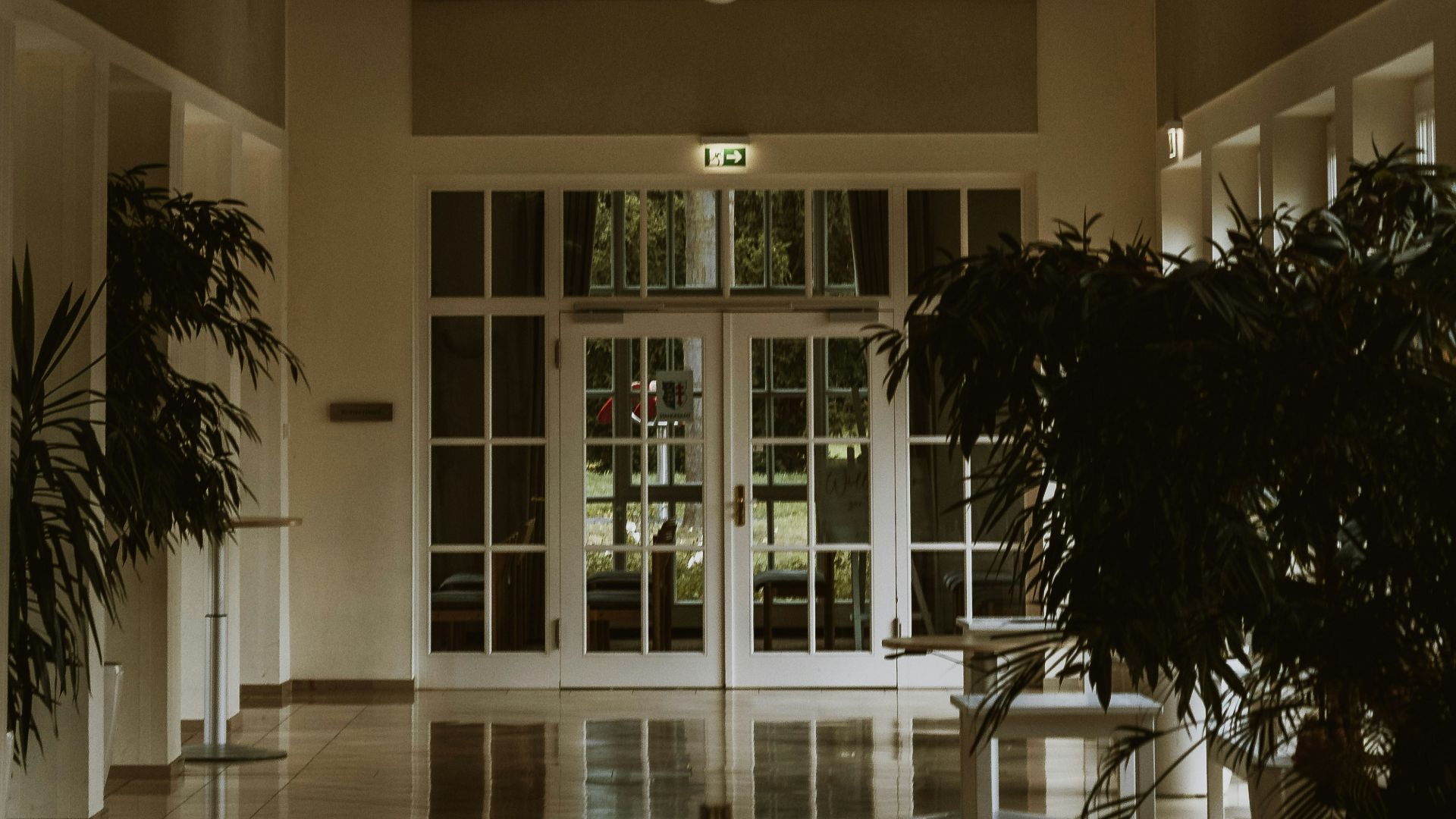 Interior hallway with arched wooden ceiling and doors.