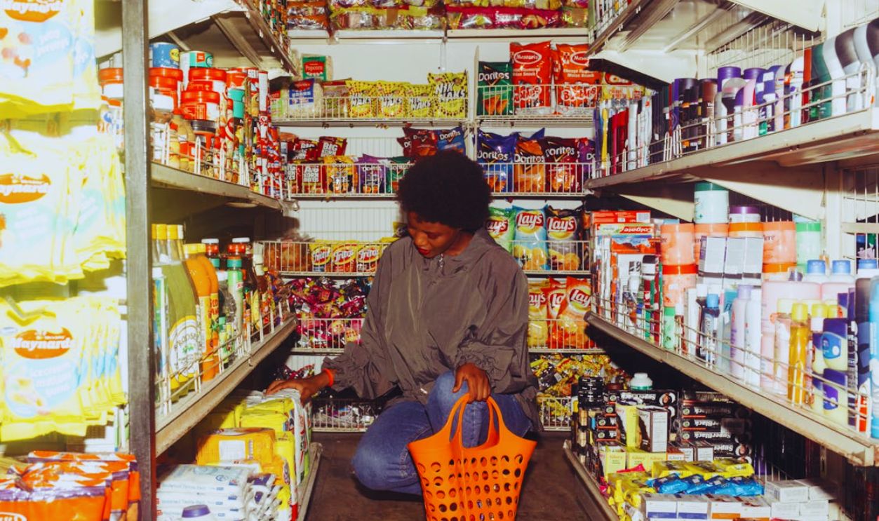 Woman Buying Groceries in a Convenience Store