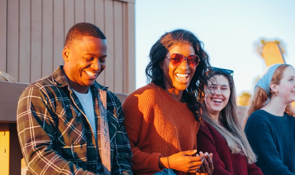 Group of Friends Sitting Near Lifeguard Post