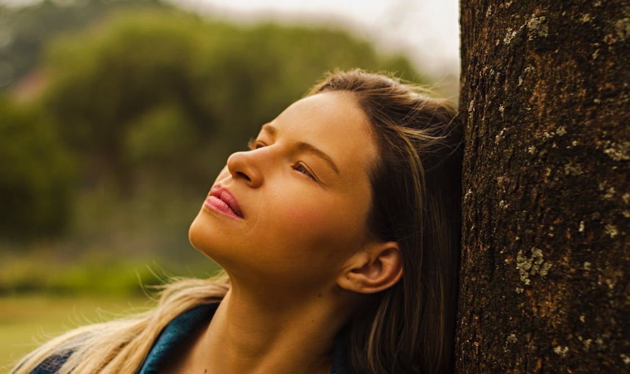 Woman Leaning her Head on a Tree
