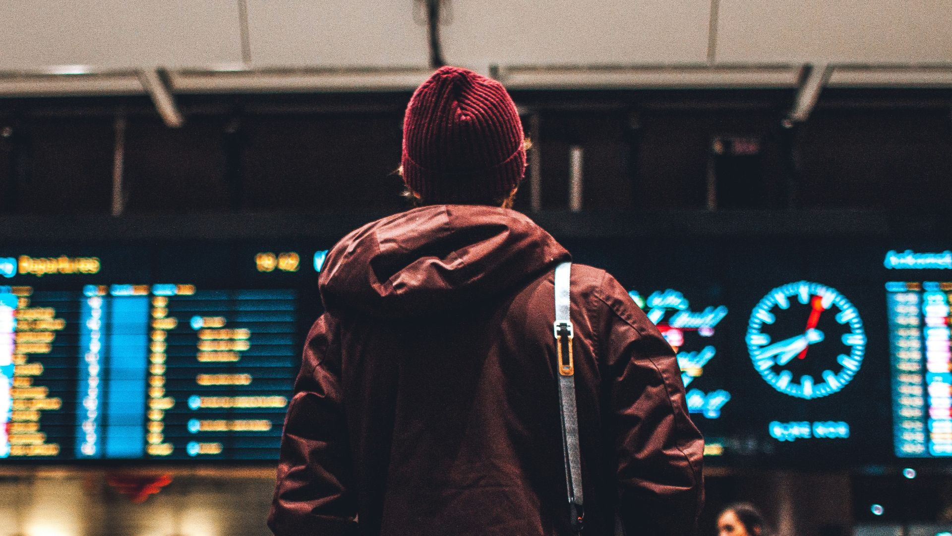 person looking up to the flight schedules