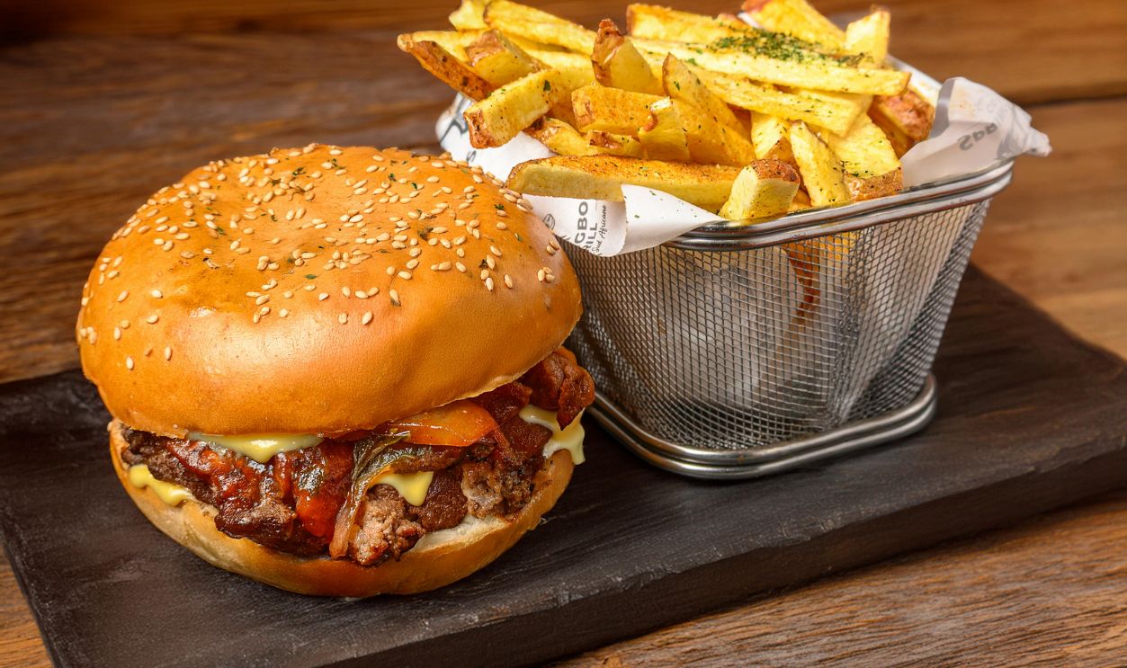 Delicious Gourmet Burger with Fries on Slate