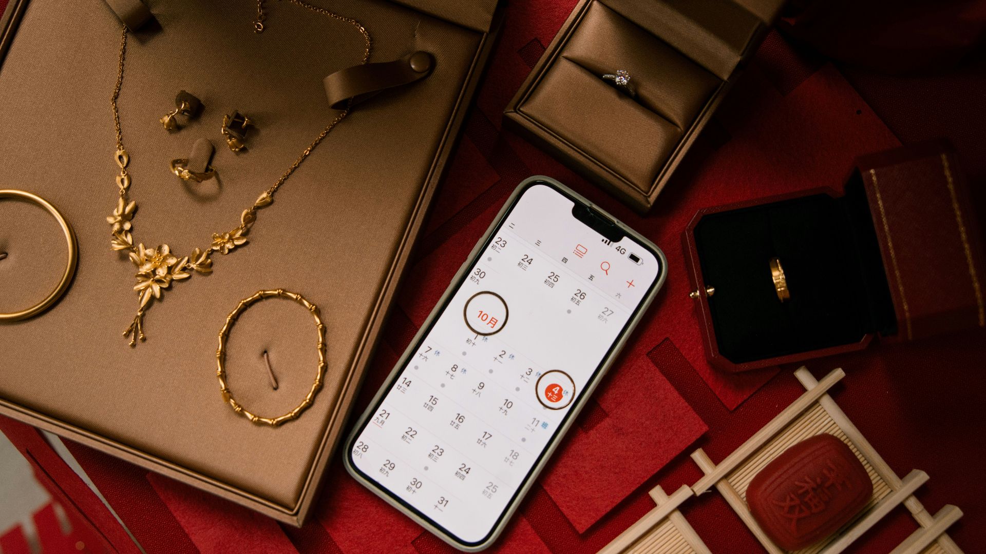 Gold jewelry and rings displayed with a smartphone.