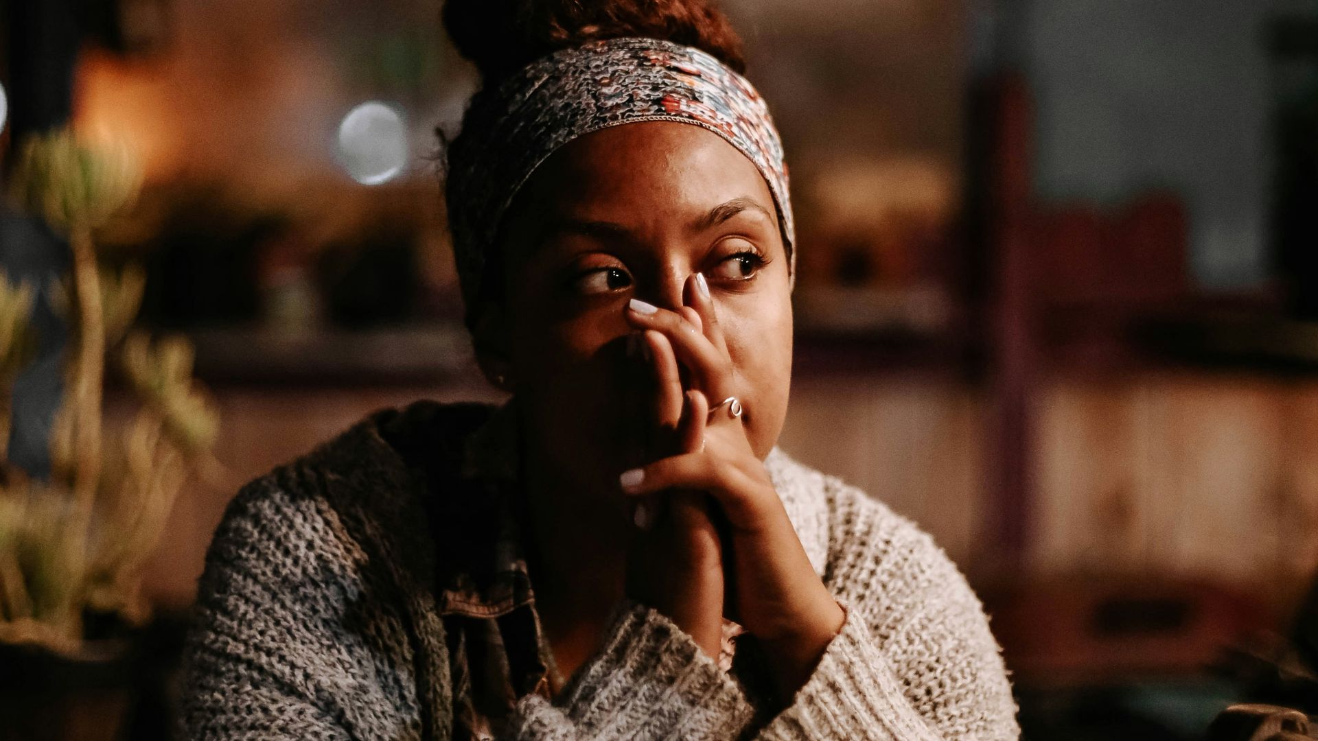 man in black and white sweater sitting on chair