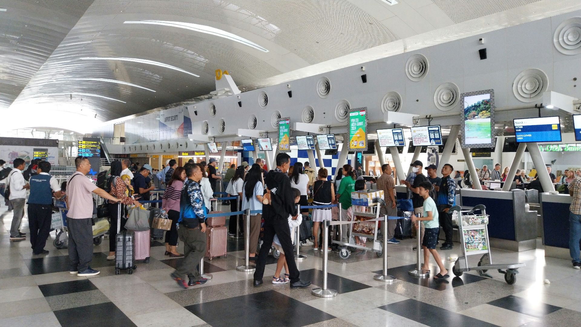 A large group of people waiting in line at an airport