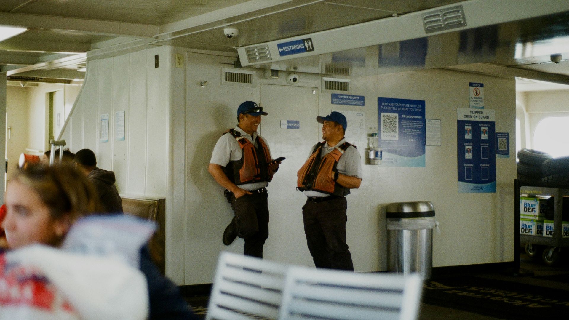 Two workers in uniform are standing inside.