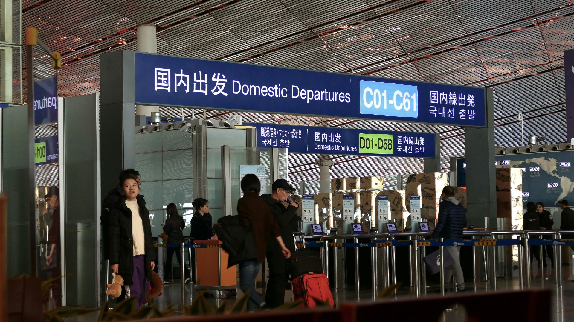 People moving through the domestic departures terminal at Beijing airport.