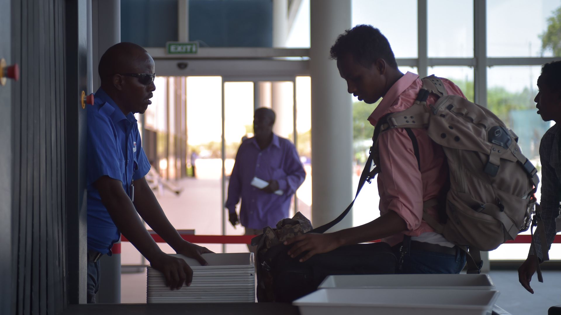 A passenger removes his luggage to be scanned through an x-ray machine at Mogadishu's Aden Adde International Airport in Somalia on April 19. After an explosion ripped a hole in the side of a Daalo Airline's airplane in February of 2016, security at Aden Adde International Airport has been drastically revamped in order to ensure similar incidents do not occur. AMISOM Photo / Tobin Jones
