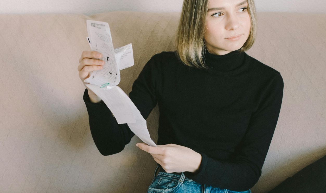 A Woman in Black Long Sleeve Shirt Sitting on the Couch