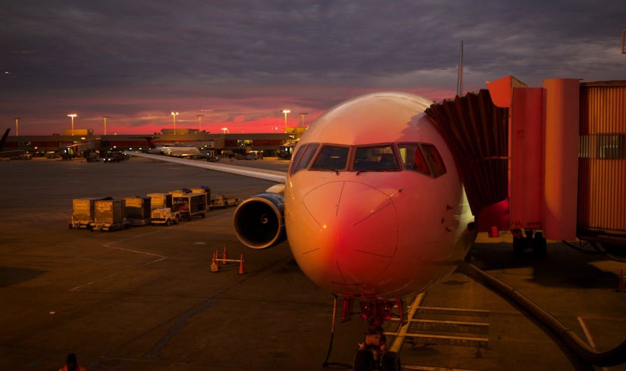 White Airplane Under Black Clouds