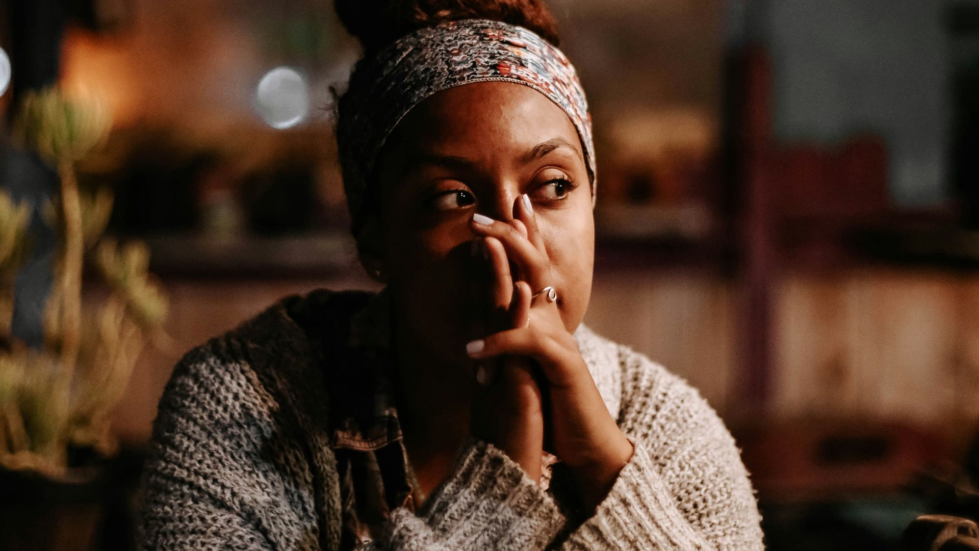 man in black and white sweater sitting on chair