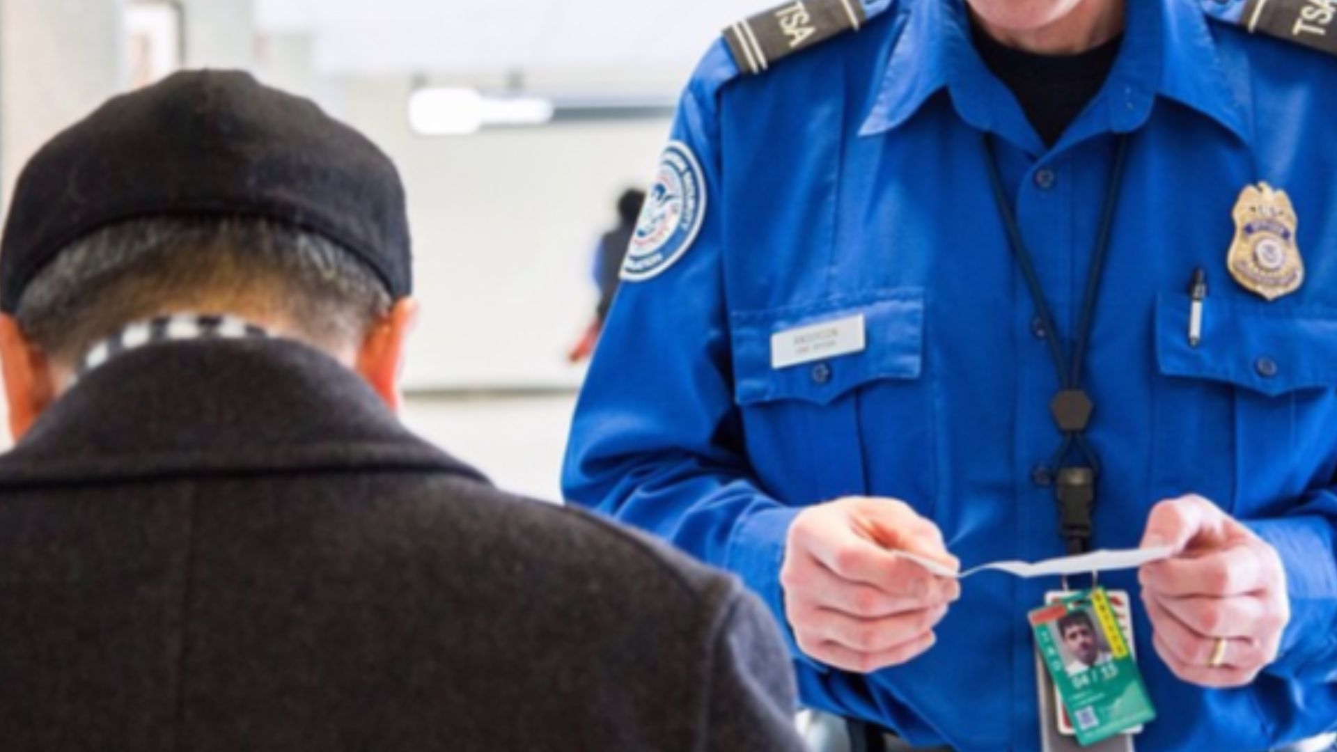 TSA officer checking a passenger's ID