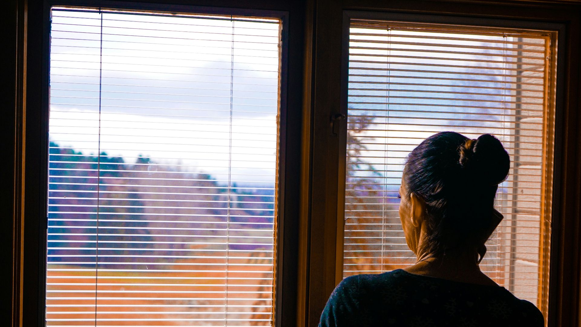 woman standing front of window