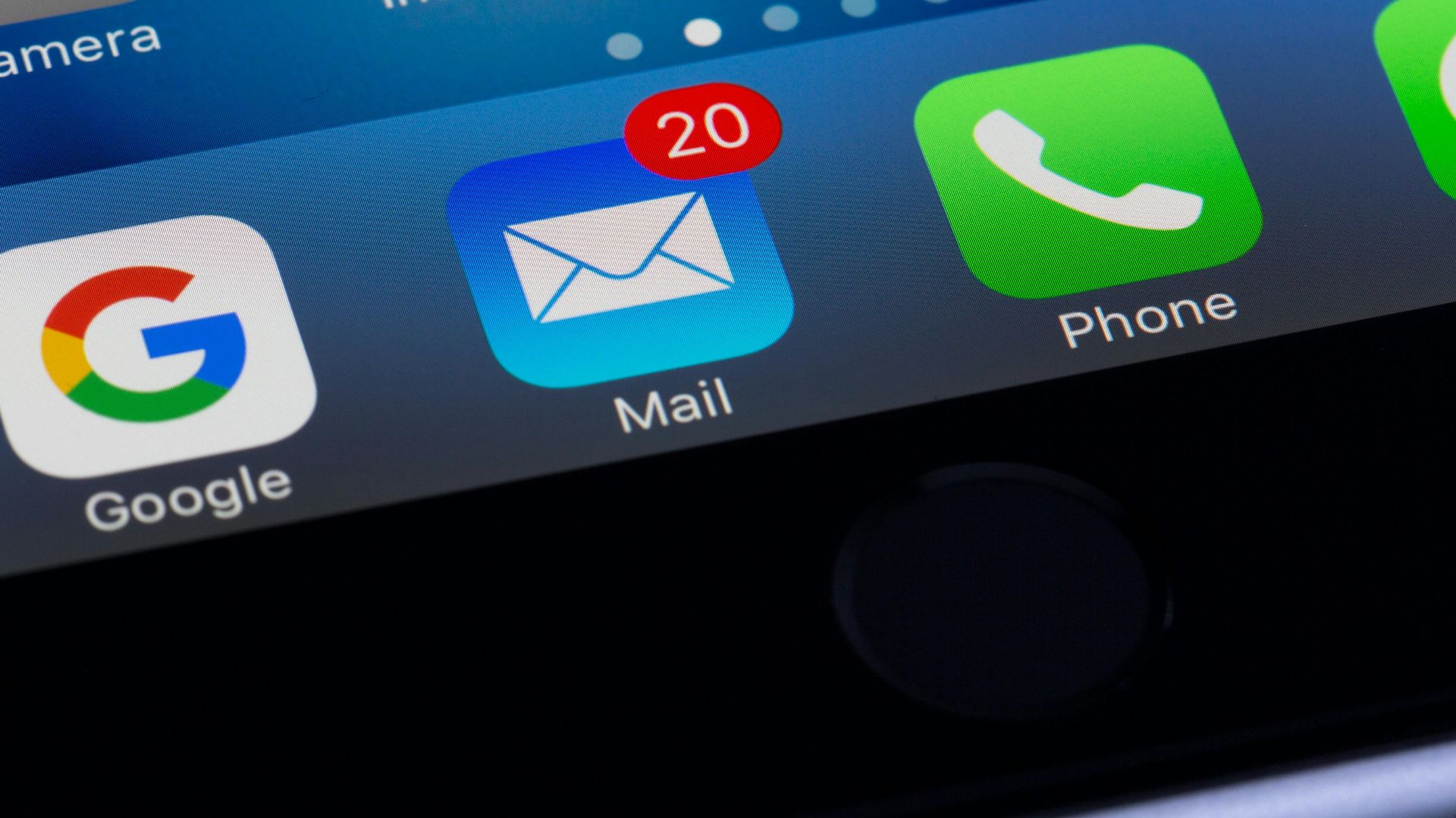 A close-up photo of a smartphone displaying popular apps like Google and Mail.