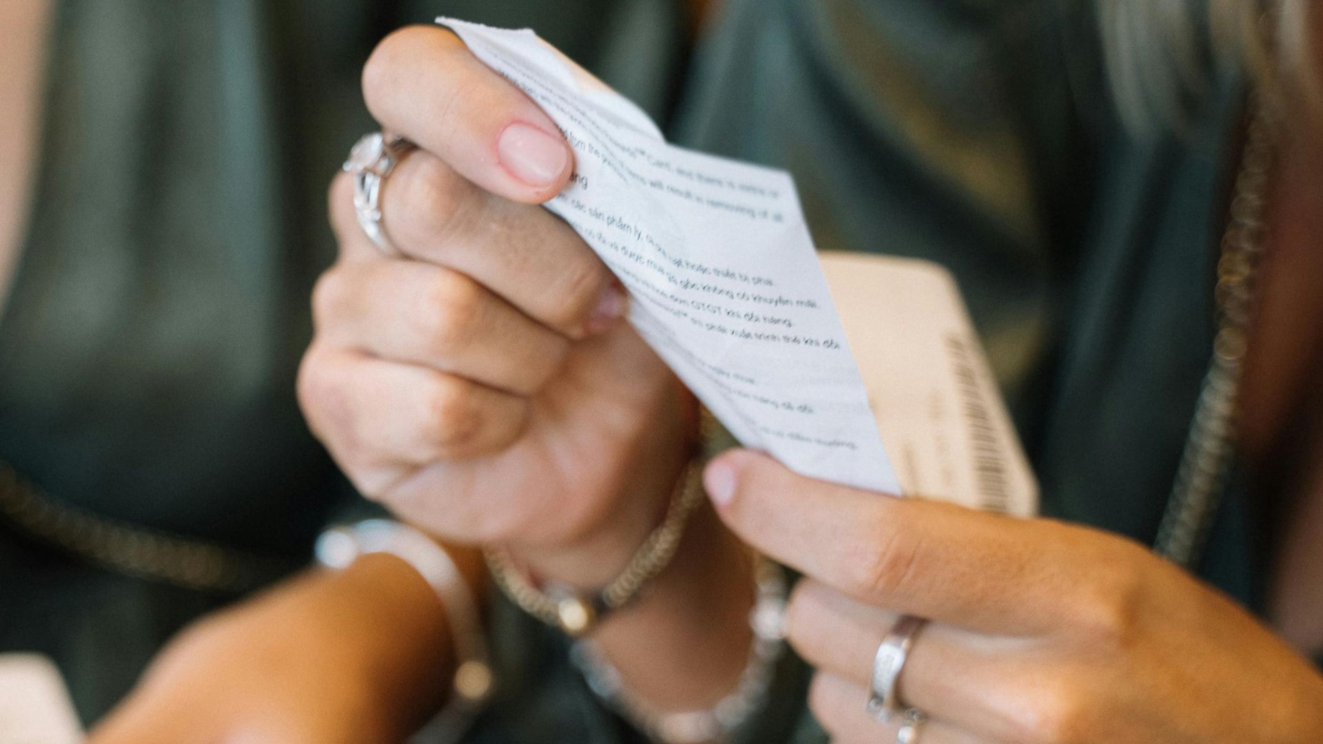 Two individuals reviewing receipts in a close-up scene, focusing on payment details.
