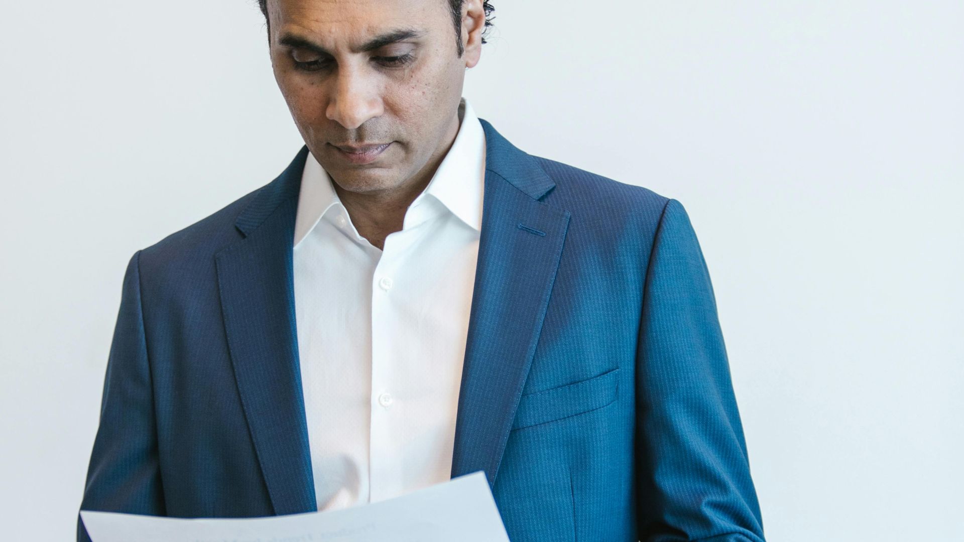 Confident businessman analyzing important documents in an office setting.