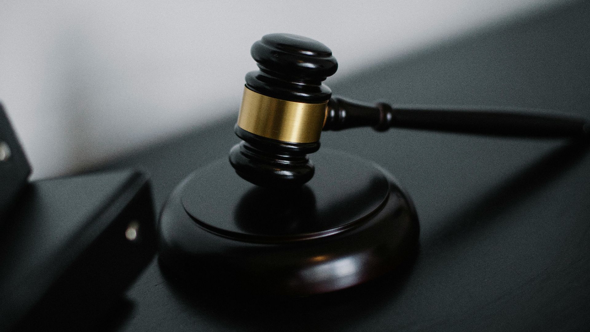 Close-up of a wooden gavel on a desk, symbolizing justice and legal authority.