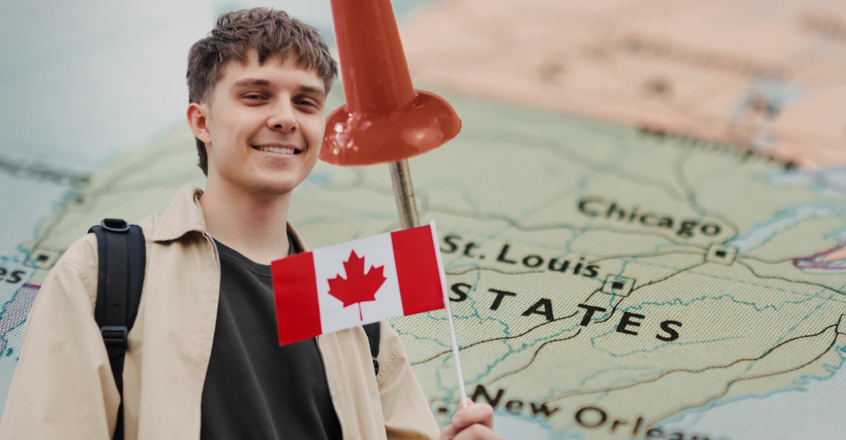 Excited smiling student with a small Canada flag 