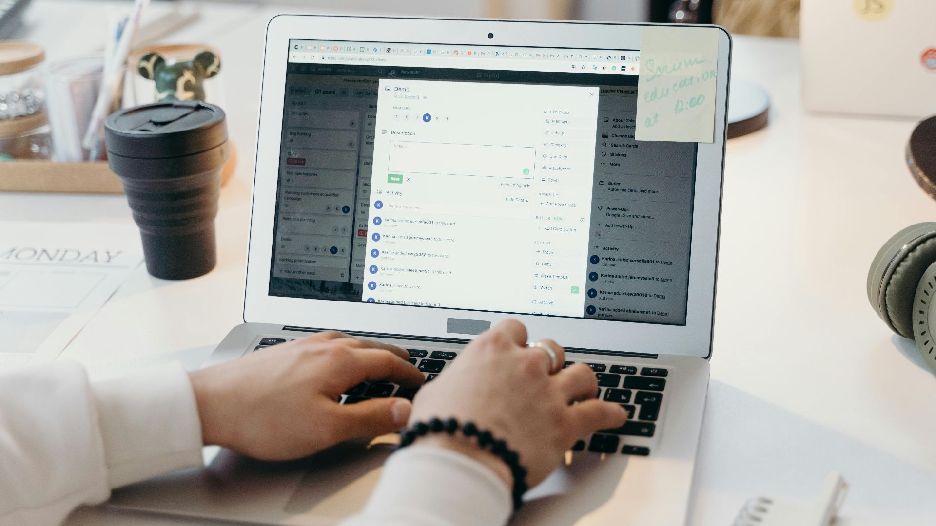 A person typing on a laptop in a bright, modern office setting, showing productivity and technology.