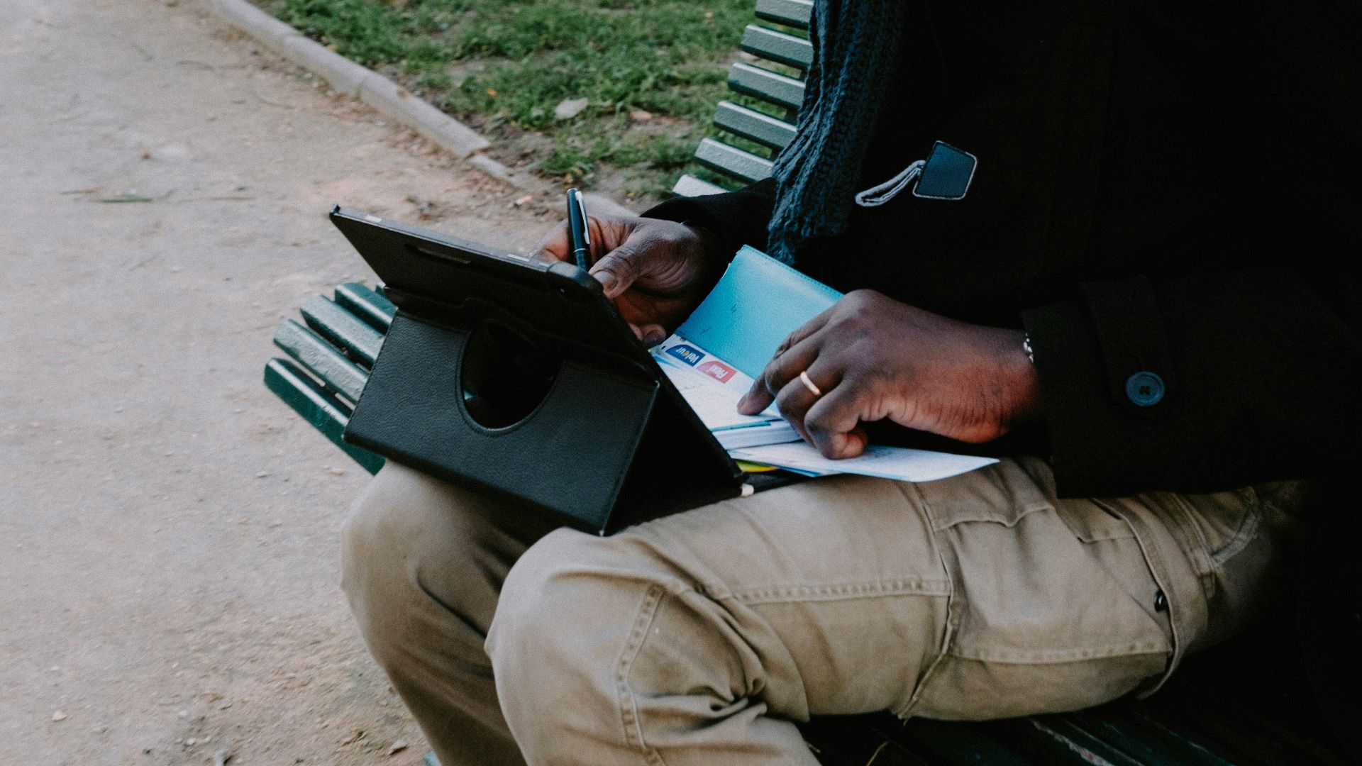 a person sitting on a bench with a laptop