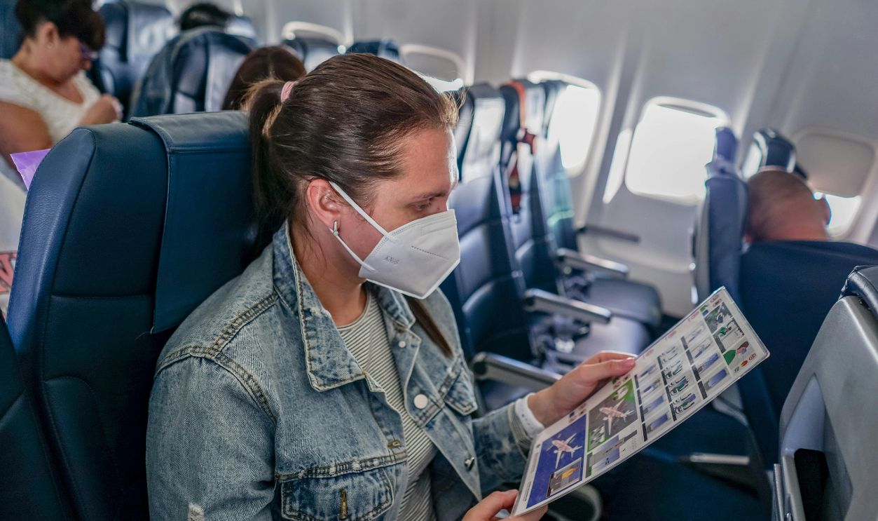 Woman in Denim Jacket Sitting inside the Plane