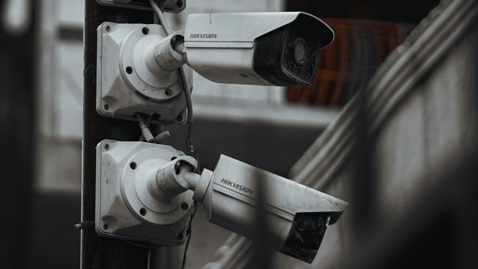 Array of security cameras on a building post, highlighting surveillance and urban security.