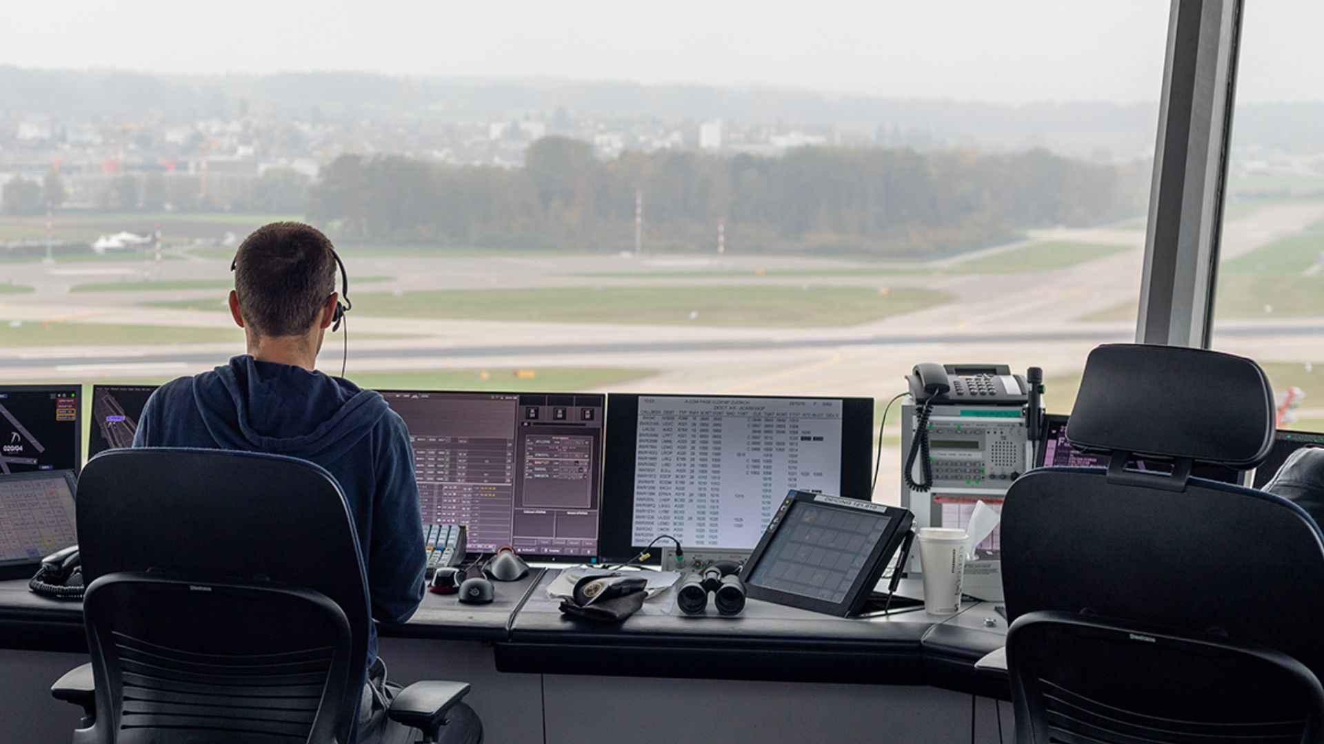 A air traffic controller from Switzerland's Skyguide working in the airport tower of Zurich.