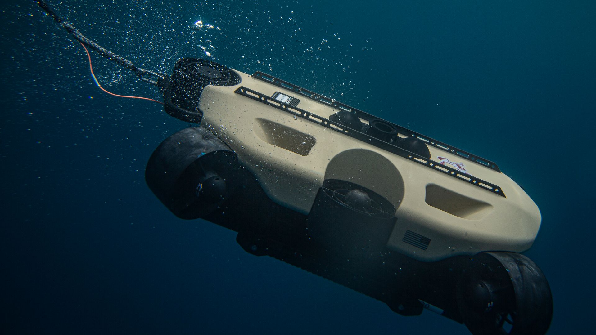 A photograph of the SRS FUSION, an unmanned underwater vehicle with sonar and video capabilities diving to the ocean floor to locate potential underwater unexploded ordnance in the coastal waters of the Republic of Palau, Oct. 13, 2021. Task Force Koa Moana 21 is a unifying mission designed to help
improve the safety of Palau by disposing of unexploded ordnance. (U.S. Marine Corps photo by Sgt. Marvin E. Lopez Navarro)