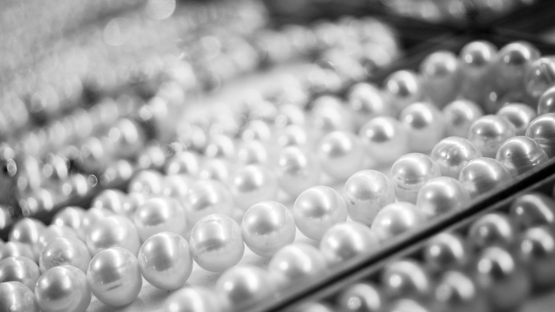 A close-up view of elegant pearl necklaces showcasing their shine and texture.