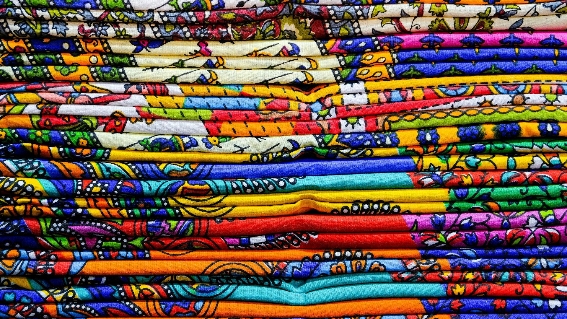 Close-up of colorful Indian textiles showcasing traditional patterns in Jaipur, India.