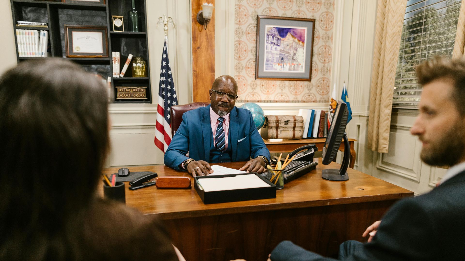 A professional lawyer meeting with clients in his office at a legal consultation.