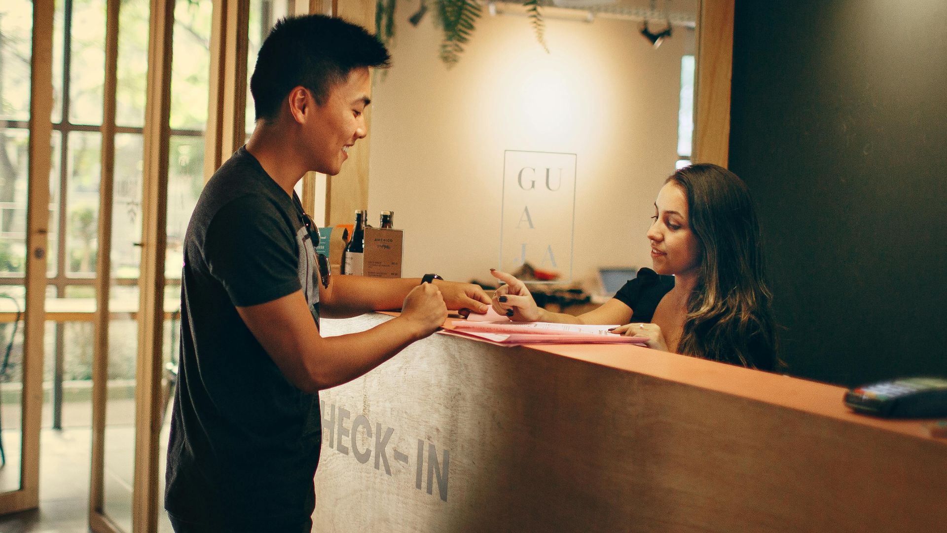 A customer checks in at a hotel reception desk in Belo Horizonte, Brazil.