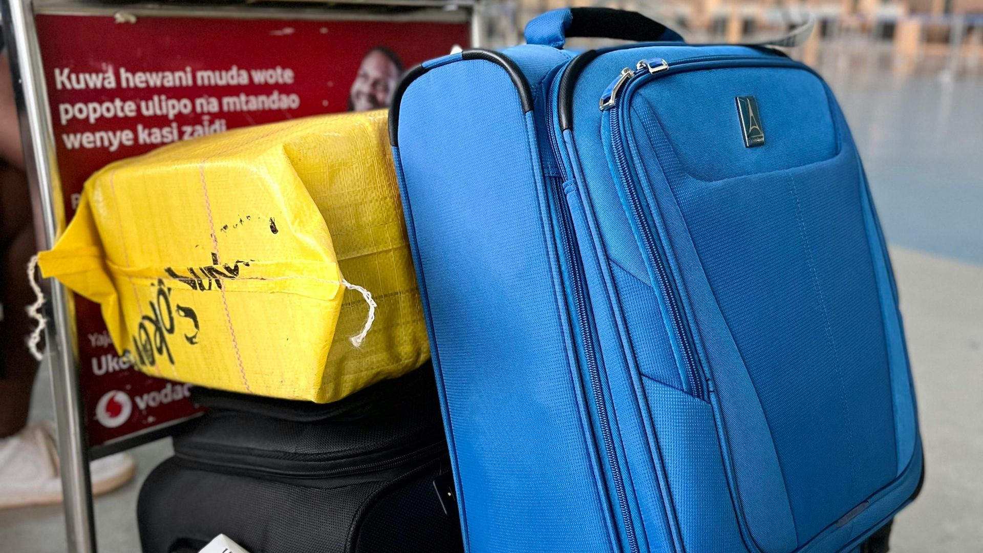 Luggage on trolley in Dar es Salaam Airport, Tanzania, showcasing travel preparation and mobility.