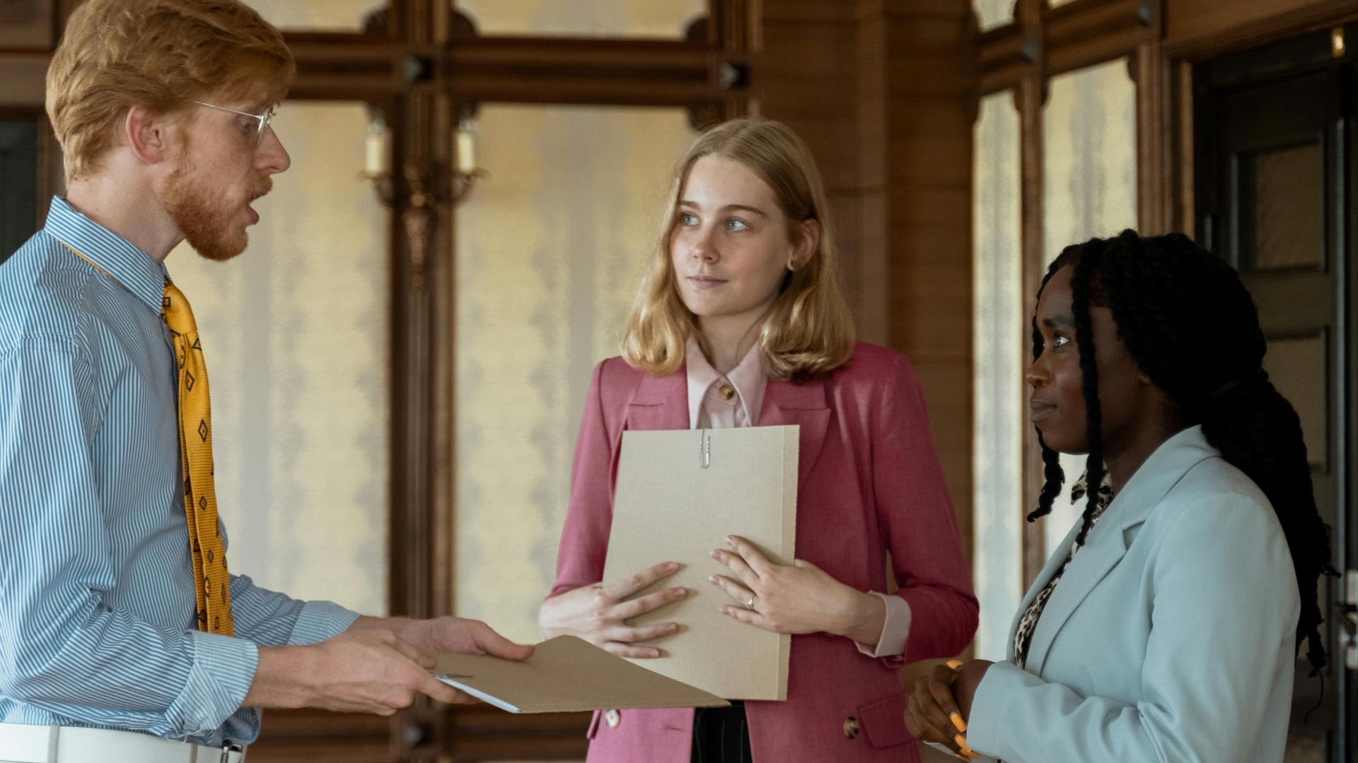 Colleagues engaging in a business meeting in a vintage-style office space.
