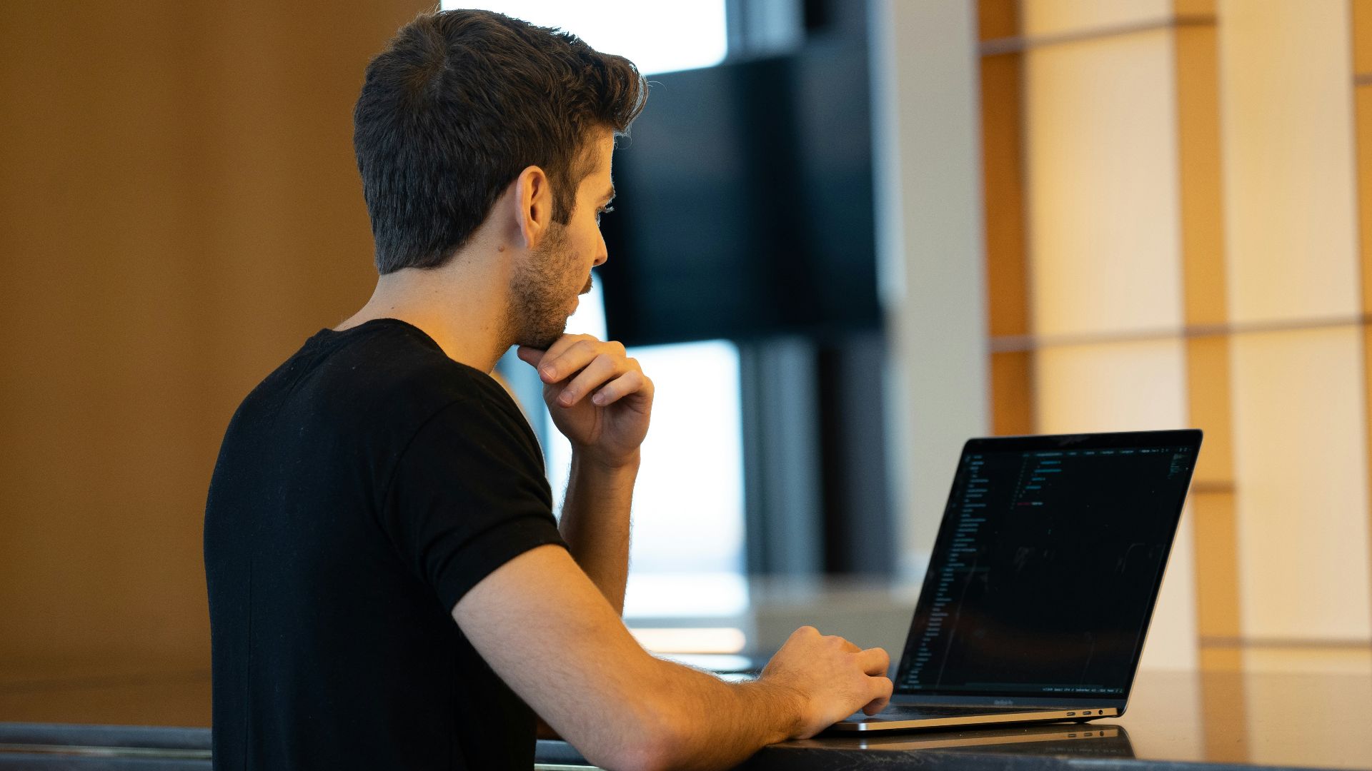man in black crew neck t-shirt using black laptop computer