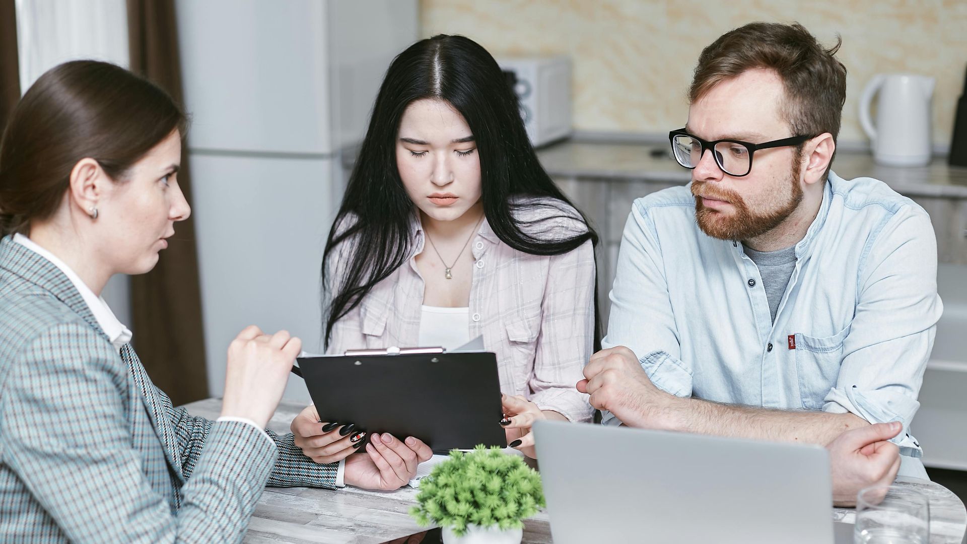 A group of professionals discussing business strategies at a table indoors.