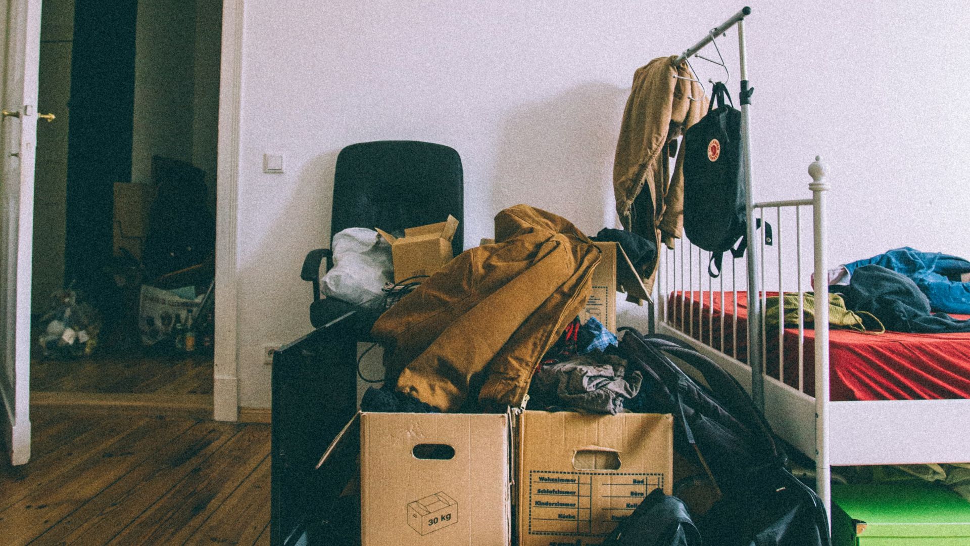 brown cardboard boxes on brown wooden parquet floor
